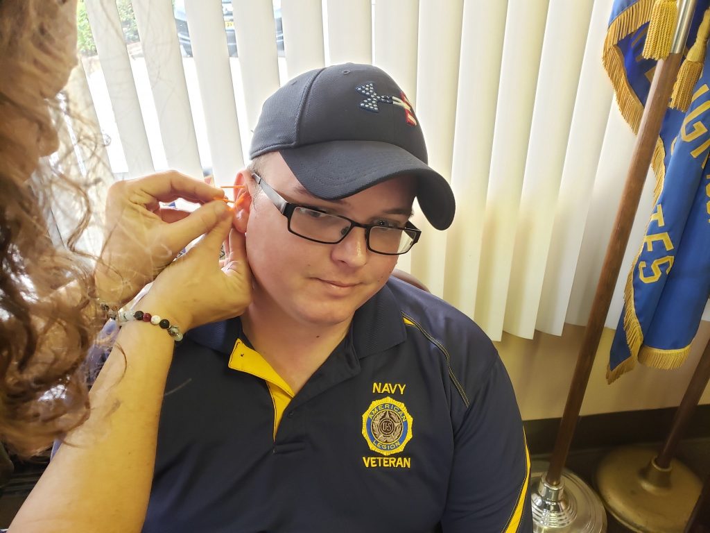 navy member receiving auricular acupuncture treatment
